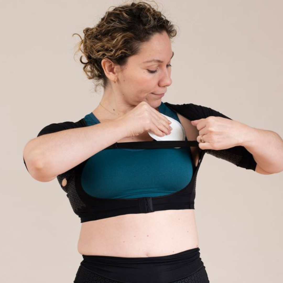 Woman wearing HidraWear AX Crop Top inserting HidraWear Dressing into underarm area