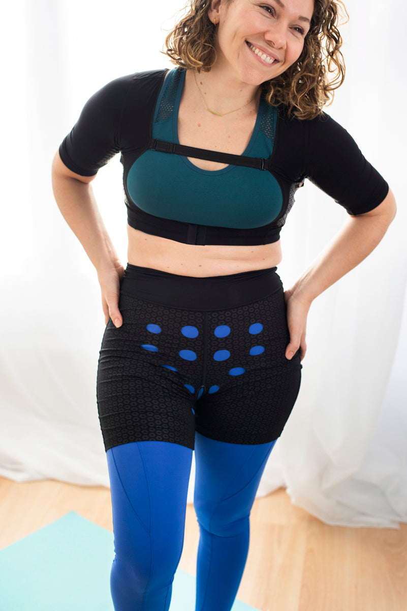 Smiling woman wearing HidraWear Briefs For Women with hands on her hips showing the ventilated area where HidraWear Dressings are placed