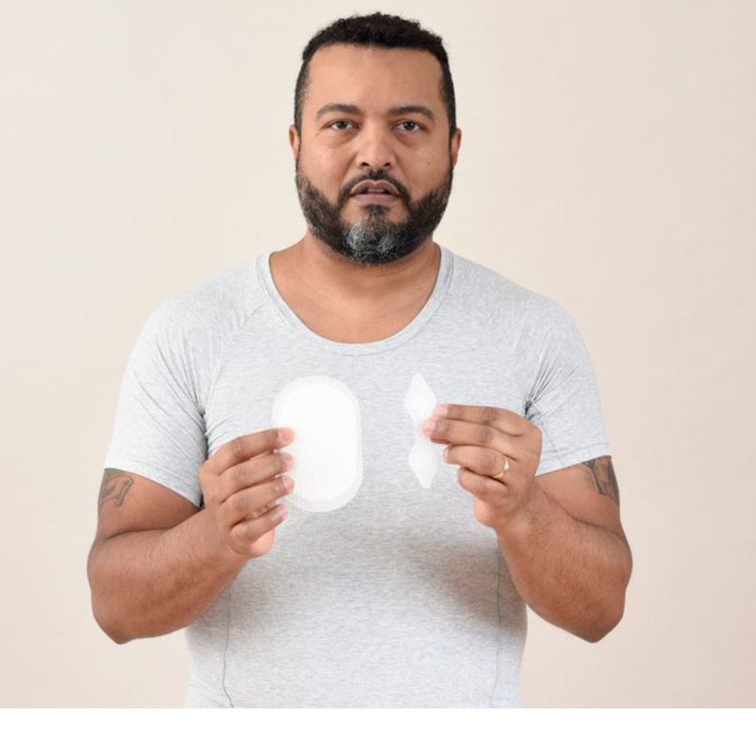 Man wearing HidraWear AX T-shirt holding HidraWear Dressings in each hand