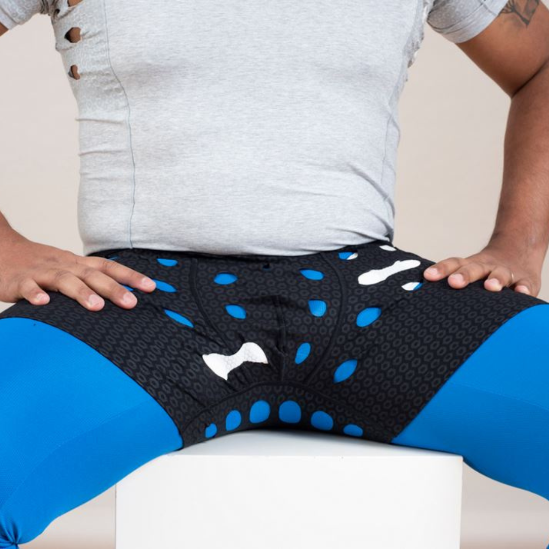 Man wearing HidraWear Boxer Briefs For Men sitting on a chair showing ventilated areas where HidraWear Dressing is placed