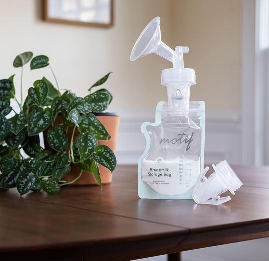 Motif Medical Pump-To-Bag Adapter shown with Motif Medical Breastmilk Storage Bag and Breast Shield to display how it works all together