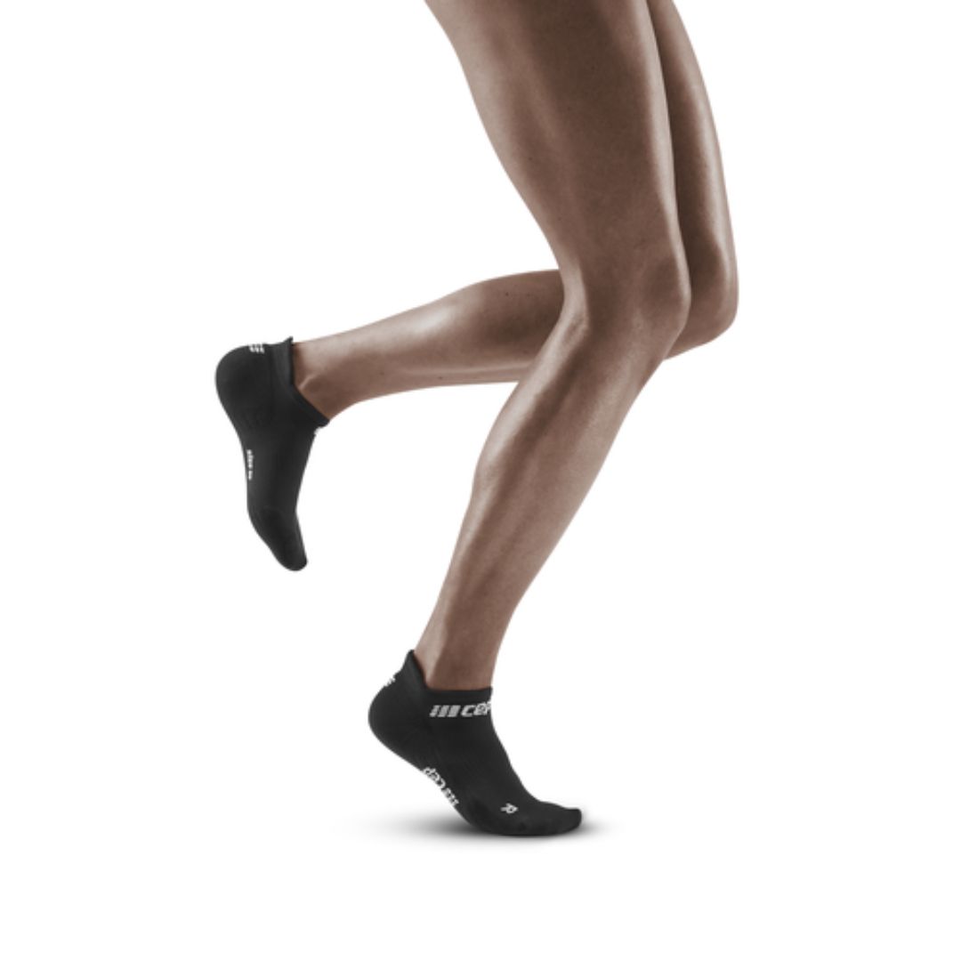 Black with white logo CEP No Show Compression Socks on a man running