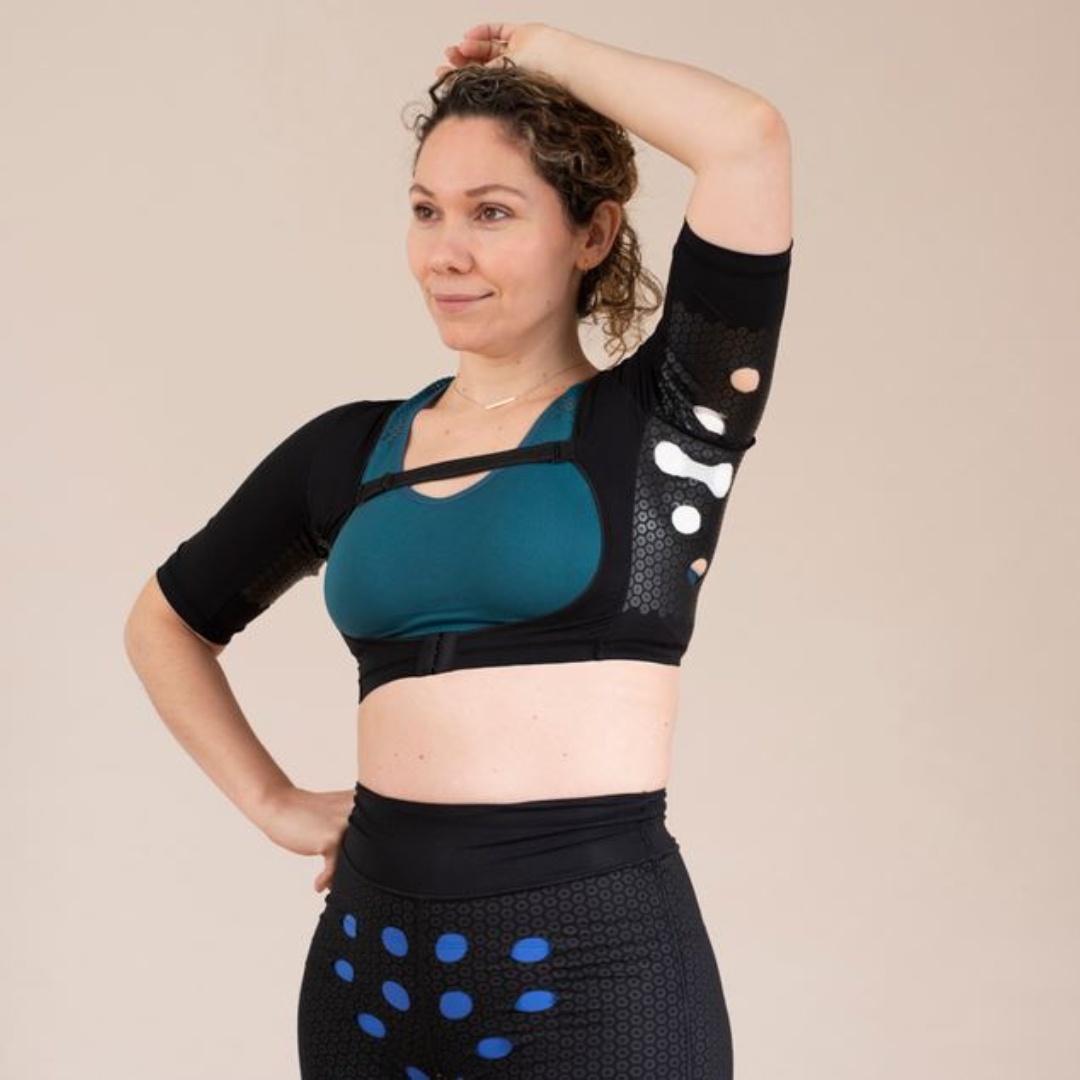 Woman wearing HidraWear AX Crop Top with arm raised to show the underarm area where dressing is held in place