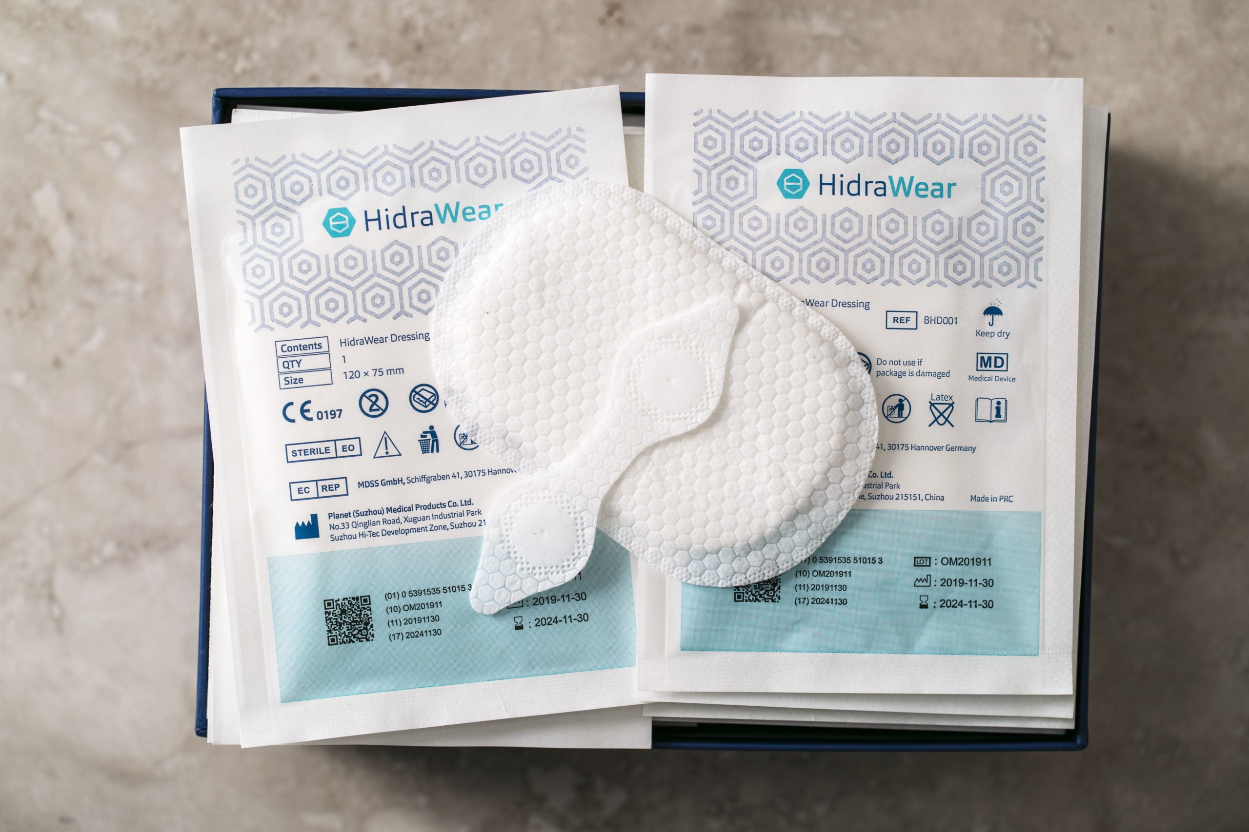HidraWear Dressings in packaging and one of each size opened on top