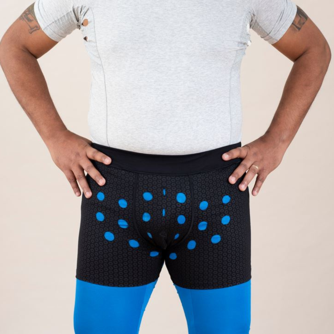 Man wearing HidraWear Boxer Briefs For Men with hands on hips showing the front ventilated areas where HidraWear Dressing is placed