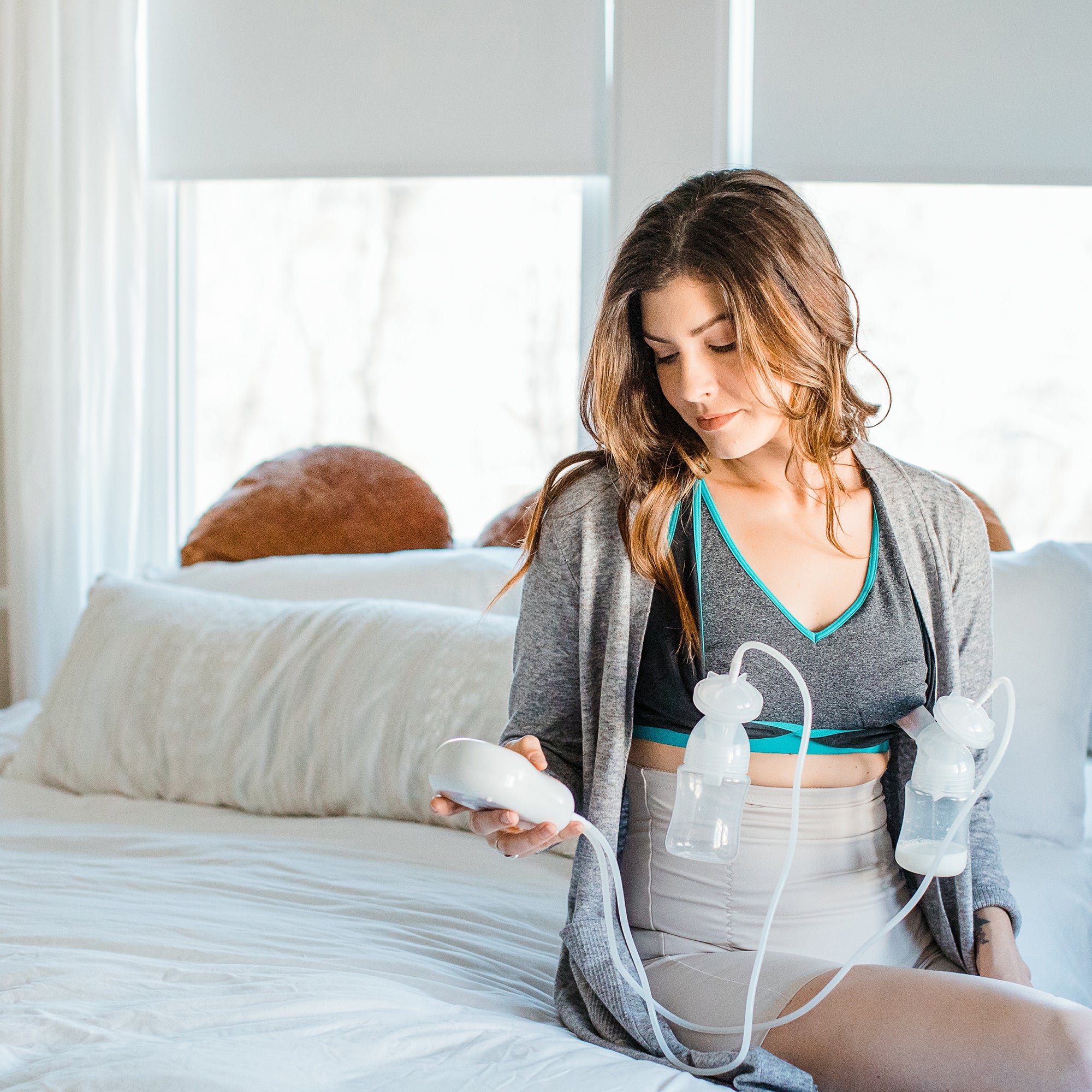 Woman Using Motif Medical Duo Double Electric Breast Pump With Hands Free Bra